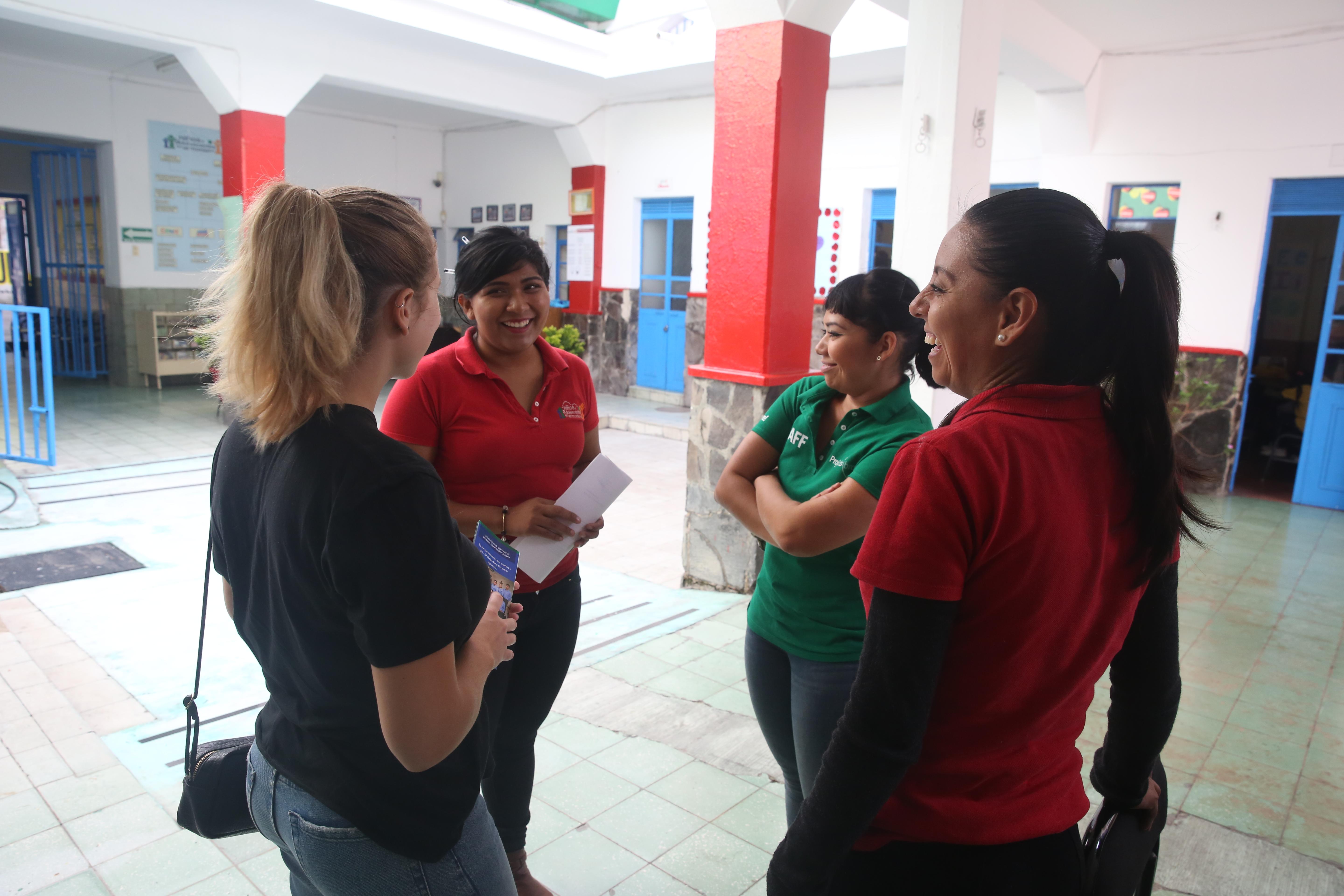 Group of Projects Abroad International Development interns standing in a circle at a Day Centre before they start their day of International Development work experience in Mexico. Female International Development interns stand in Day Centre prior to their progress meeting during their internship in Mexico.